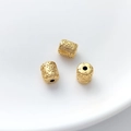 Macro shot of three gold barrel beads with detailed floral relief for DIY jewelry making - Vintage Embossed Pattern Barrel Bead (10#) / 1 Piece (6.5x7.7mm)