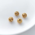 Macro detail of four gold hollow filigree beads for DIY jewelry making and bracelets - Fret Pattern Hollow Round Bead (16#) / 1 Piece (8x8.5mm)