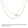 Detailed view of gold double layer necklace with small pearls and snake chain - Layered Gold