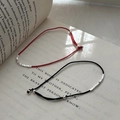 Minimalist red and black braided rope bracelet with silver beads on a vintage book page - 925 Silver / Red
