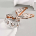 Hammered silver metal cuff bracelet featuring an elegant brown and white silk scarf bow - Silver Bracelet With Radial Scarf