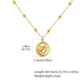 Macro shot of gold bead chain necklace with resin ocean pendant and shell detail - Necklace