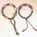 Dettaglio di bracciali etnici in ceramica con perline, nodi fatti a mano e trama marmorea - MU28