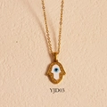 Hamsa hand necklace with blue evil eye pendant in 24k gold plating on a textured backdrop - Hamsa Hand Style (YJD03) / Necklace / Gold