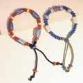 Bracciale etnico in ceramica con perline, motivi ossei e cordoncino intrecciato - MU14