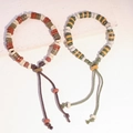 Braccialetti etnici con perline di ceramica e scritte in osso d'oracolo in toni terra - MU17