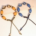 Bracciale etnico con perle di ceramica con motivi di ossa oracolari e cordino intrecciato - MU22