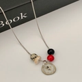 Retro slangenketting met knophanger en gedessineerde kralen voor een vintage uitstraling - Vintage Gevlekte Kralenketting
