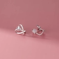 Minimalist silver heart-shaped ear clips with comfortable clear silicone pads on pink backdrop - Mosquito Coil Ear Clip / Silver