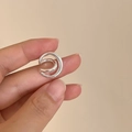 Close-up of a minimalist silver double-layer ear cuff held to show its small size - C-Shape Double Line (ED2172) / Single Piece