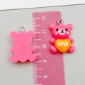 Detail view of 2cm pink resin bear pendants with LOVE heart and silver metal rings - Rose Red (24493)
