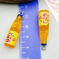 Miniature orange soda resin bottle charm with metal ring and ruler for size scale - Small Bottle Style (24648) / Transparent Orange