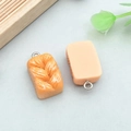 DIY charm set featuring resin orange twist bread and sliced toast with metal rings - Yellow Resin Toast Shredded Bread (24639)