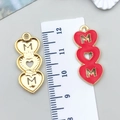 Detailed view of pink enamel heart MOM pendant with measurement ruler for scale - KC Gold Red Enamel Hollow Heart / 28*12mm