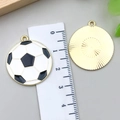 Macro detail of 25mm soccer charms with green oil drip enamel and golden back texture - Enamel Football Style (18644) / 25x28mm
