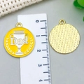 Detailed view of 2.5cm Father's Day yellow enamel pendant with trophy and Dad engraving - Yellow Badge (23014)