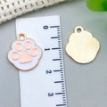 Macro detail of enamel paw print charm showing exact size measurements on a ruler - 17*15mm / Pink Enamel Paw (18834)