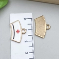 Detail of white enamel nurse hat charm with red cross and golden honeycomb texture back - White Enamel Nurse Hat 20*14mm (12004)