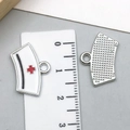 Detail of 1.5cm white enamel nurse hat charm with red cross and textured silver back - White Nurse Hat (23228)