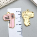 Detailed macro view of front and back thermometer charms with ruler for size reference - Pink Enamel Thermometer