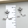 Detailed size view of silver golf club and ball charms with a ruler measurement - Golf Ball Shape (22263) / Antique Silver