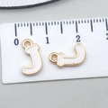 White enamel gold letter J charms for DIY jewelry making with ruler for size reference - Letter J