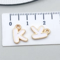 Golden letter K charm with white enamel for DIY necklaces, measuring 1.2 cm in height - Letter K