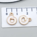 Golden heart-shaped white enamel letter pendant with ruler showing 15mm diameter size - Letter O