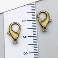 Macro detail of antique bronze lobster clasps with measurement scale for DIY jewelry - Antique Bronze