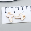 Golden letter T charm with white enamel on a measuring scale for DIY jewelry making - Letter T