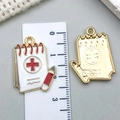 White enamel medical notebook pendant with red cross symbol and golden metal back - White Enamel Medical Record Book