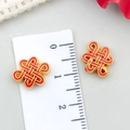 Macro shot of red enamel Chinese knot pendant with ruler showing 1.2cm width - Small Chinese Knot Spacer Bead (22842) / 1 Piece (14x10mm) / Red Enamel Bright Gold