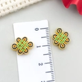 Detail view of red enamel Chinese knot pendant showing dimensions of 1.2cm with a ruler - Small Chinese Knot Spacer Bead (22841) / 1 Piece (14x10mm) / Black Oil Bright Gold