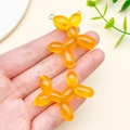 Set of two orange glitter resin balloon dog pendants with metal hooks for DIY jewelry - Fine Glitter Orange