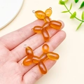 Pair of amber glitter resin balloon dog charms with silver rings for DIY jewelry making - Glitter Coffee
