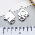 Antique silver graduation cap and diploma charms with detailed engraved textures - Graduation Cap (10895)