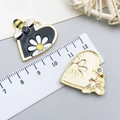 Heart-shaped enamel bee and daisy charms in black and gold finish with size reference - Black Gold Heart Bee Flower (23595)