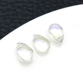 Three teardrop opalite glass pendants with iridescent glow on black and white backdrop - White