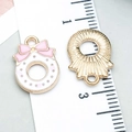 Pink bow Christmas charm with white enamel and golden alloy back on a ruler scale - Pink Enamel Christmas Wreath Style (24819)