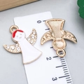 Detail of angel pendant with white enamel and crystals on a measuring scale board - White Enamel Christmas Angel