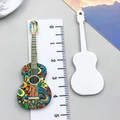 Macro detail of acrylic guitar pendant showing colorful abstract pattern and white back - Multicolor Single Sided Printed Music Guitar (24035)