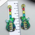 Ciondolo a forma di chitarra in acrilico verde con motivi astratti e altezza di 50mm - Chitarra Verde (24039)