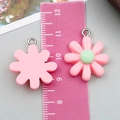 Pink resin sunflower charms for DIY jewelry making shown with size measuring ruler - Pink Resin Eight-petal Flower Style