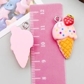 Close-up of resin ice cream cone charm with pink cream, strawberry and silver loop - Pink