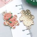 Gingerbread man enamel charm pendant with golden metallic back and size scale view - Brown Enamel Gingerbread Man (19678)