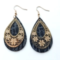 Detailed view of teardrop earrings with gold hollow floral metal and black textured leather - Water Drop Flower Style / Black Texture