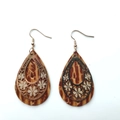 Macro detail of vintage teardrop leather earrings with golden hollow flower pattern overlay - Water Drop Flower Style / Brownish Texture