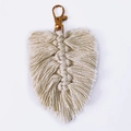 Detail of bohemian handmade woven cotton leaf pendant with golden lobster clasp and fringe - Leaf Style / Off White