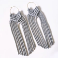 Handmade light grey macrame fringe earrings with gold metal hoops on white background - Light Gray