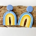 Detail of colorful polymer clay rainbow earrings on natural tree bark background - Dark Blue Light Blue Orange Beige Stitching Rainbow